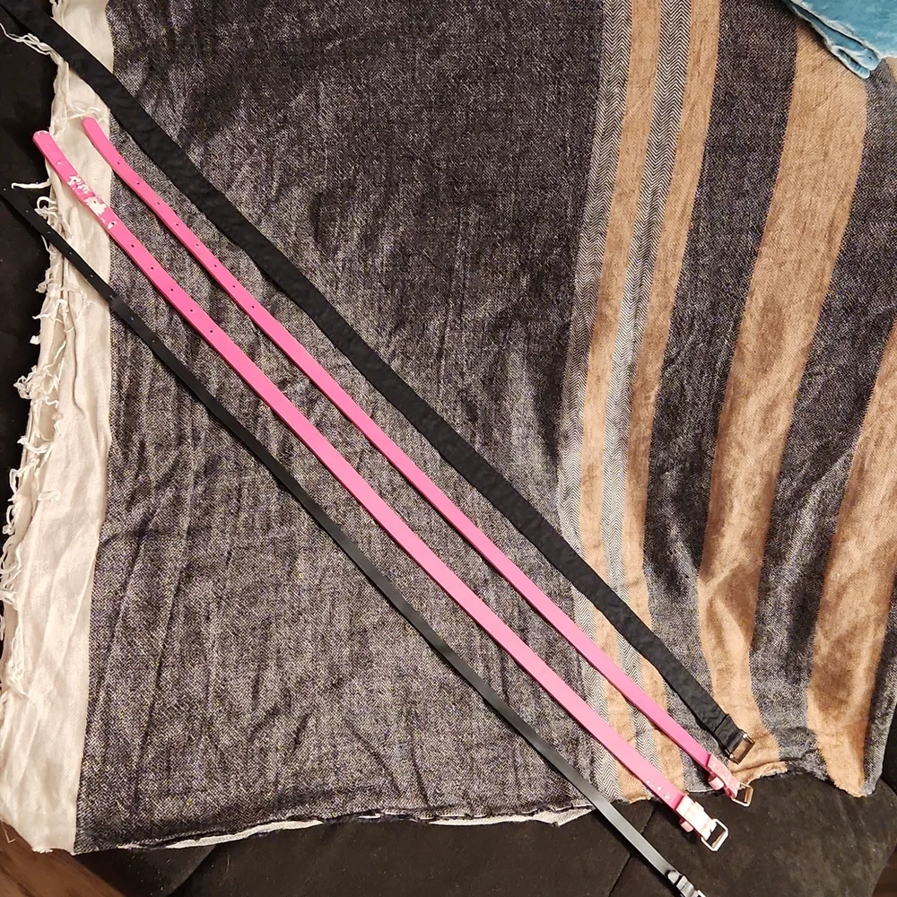 4 used belts printed pink and solid black